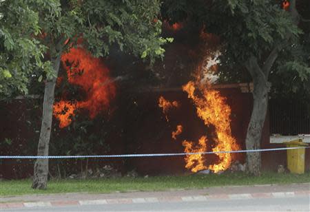 Flames erupt as a bomb, which was discovered outside of Cambodia's National Assembly, is detonated by Cambodian Mine Action Center (CMAC) personnel in central Phnom Penh September 13, 2013. REUTERS/Samrang Pring