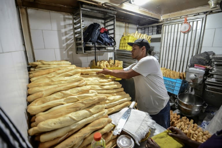 Members of a pro-government community organisation work in an expropriated bakery in Caracas