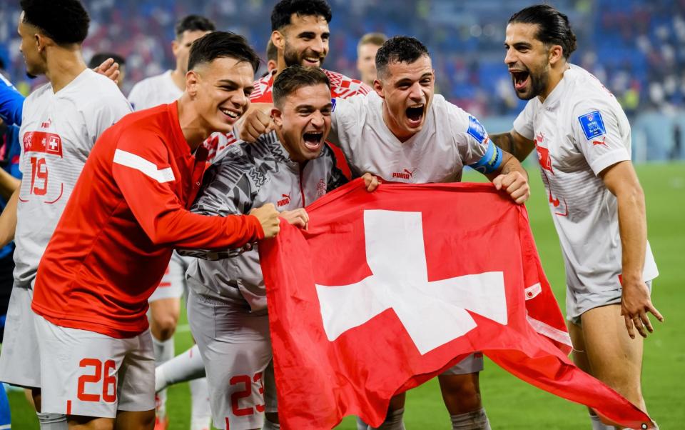 Switzerland players with Swiss flag - Portugal vs Switzerland, World Cup 2022 last 16: Date, kick-off time and TV channel - Laurent Gillieron/Shutterstock