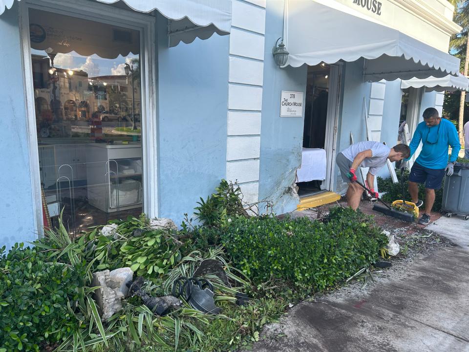 Workers clean up the damage caused by Wednesday's crash.