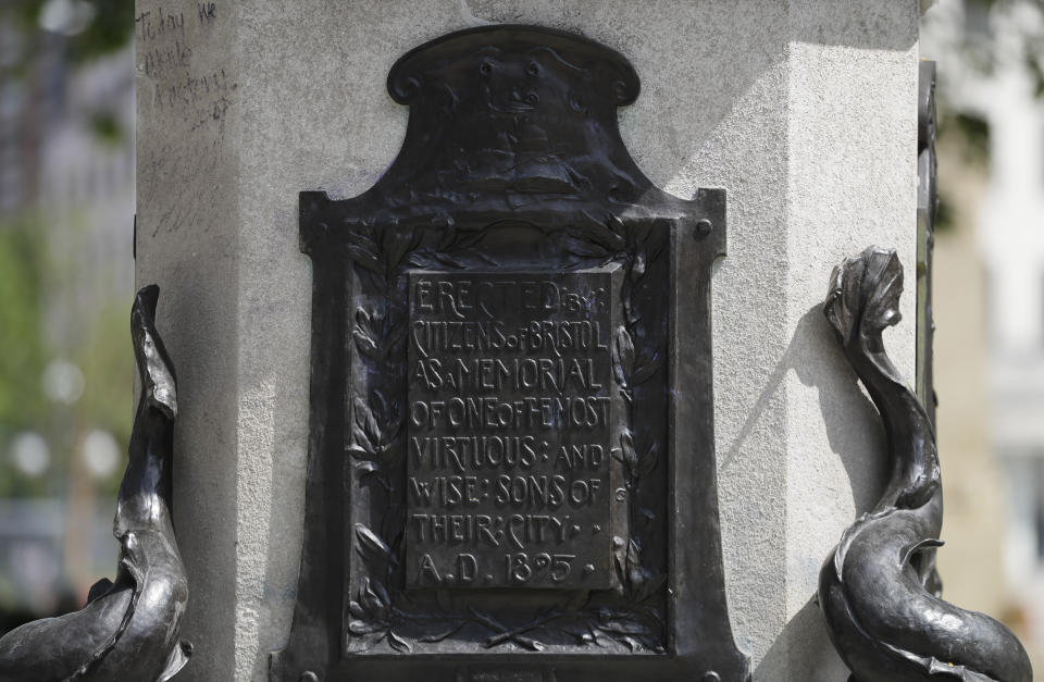 An inscription on the pedestal of the toppled statue of Edward Colston in Bristol, England, Monday, June 8, 2020, following the downing of the statue on Sunday at a Black Lives Matter demo. The toppling of the statue was greeted with joyous scenes, recognition of the fact that he was a notorious slave trader — a badge of shame in what is one of Britain’s most liberal cities. (AP Photo/Kirsty Wigglesworth)