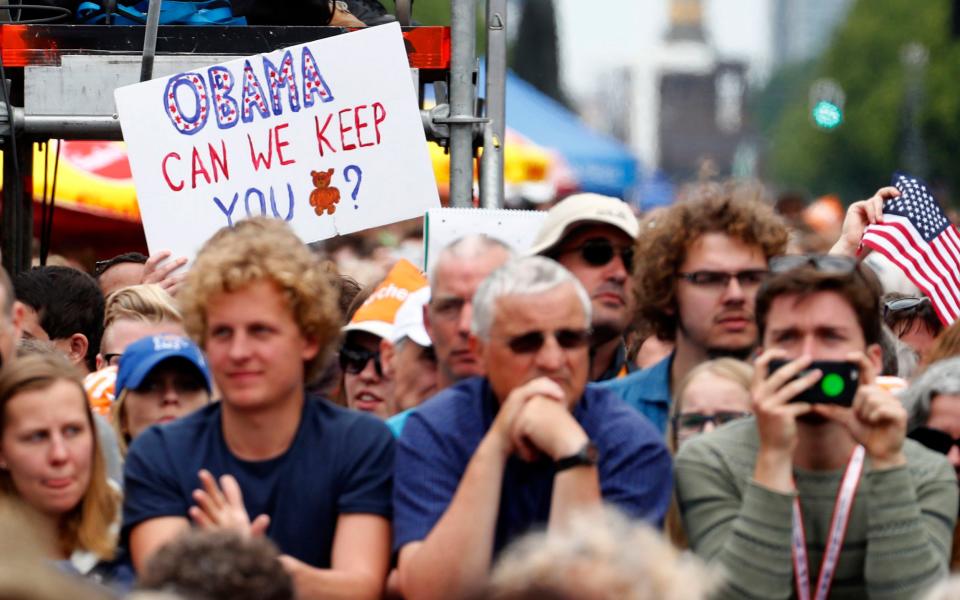 Fans await the arrival of former U.S. President Barack Obama at the German Protestant Kirchentag in front of the Brandenburg Gate in Berlin - Credit: FABRIZIO BENSCH/REUTERS