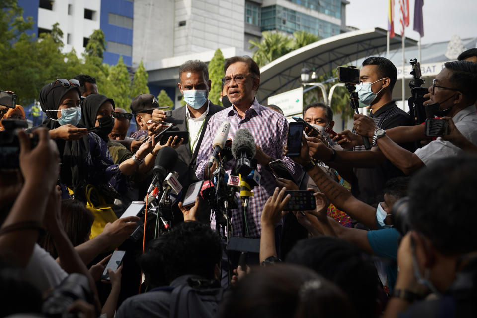 Malaysian opposition leader Anwar Ibrahim speaks to media after leaving the police headquarters in Kuala Lumpur, Malaysia, Friday, Oct. 16, 2020. Anwar was questioned by police over the dissemination of a purported list of lawmakers supporting his bid to oust the government. (AP Photo/Vincent Thian)