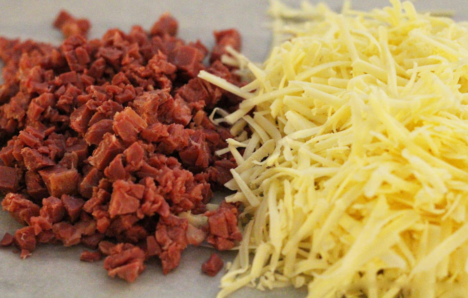 <p>Chop the corned beef and shred the Swiss cheese.</p>