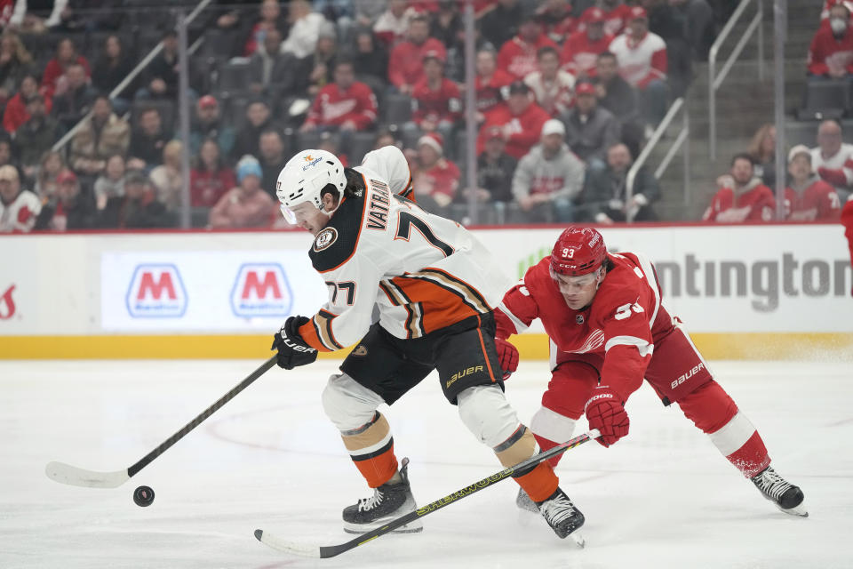 Anaheim Ducks right wing Frank Vatrano (77) controls the puck next to Detroit Red Wings right wing Alex DeBrincat (93) during the first period of an NHL hockey game, Monday, Dec. 18, 2023, in Detroit. (AP Photo/Carlos Osorio)