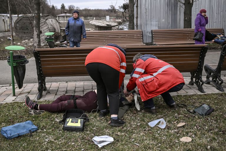 Paramédicos trabajan en la reanimación de una mujer luego del estallido de una bomba de racimo en Kramatorsk, Donbass