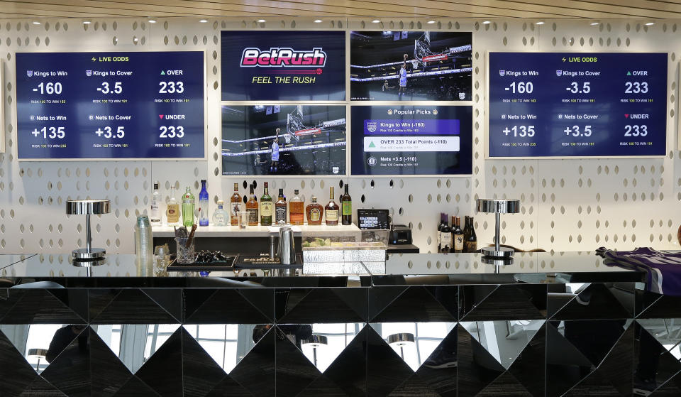 FILE - In this March 19, 2019, file photo, video screens display the types of bets that can be placed at the Golden 1 Center's Skyloft Predictive Gaming Lounge, in Sacramento, Calif. Professional sports leagues have found a way to cash in by selling their official data to gambling companies, making the case that the leagues are creating new products for gamblers to bet on. (AP Photo/Rich Pedroncelli, File)