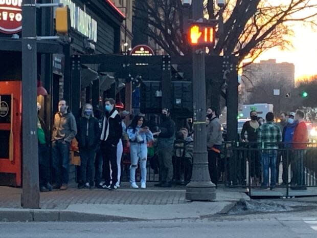 Some patrons lining up to get into a popular bar on Whyte Avenue in March did not follow physical distancing rules.   (Natasha Riebe/CBC - image credit)