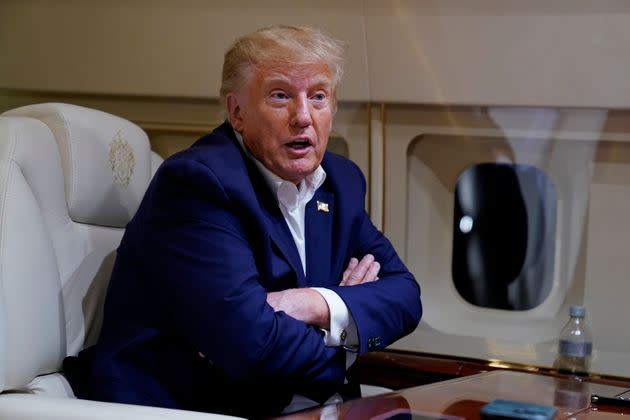 Former President Donald Trump speaks with reporters while in flight on his plane after a campaign rally in Waco, Texas on Saturday.