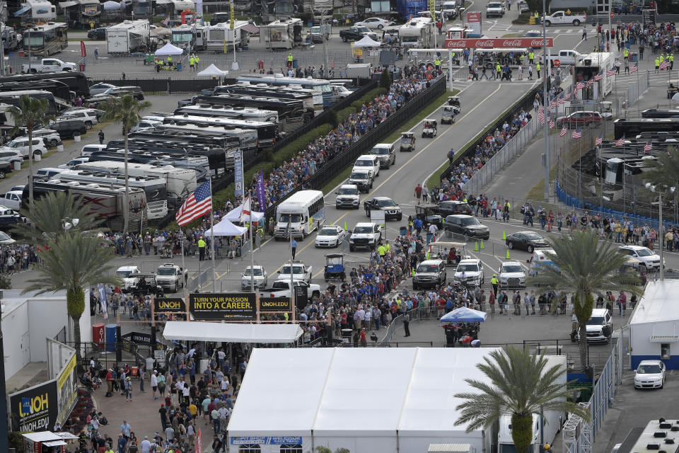 Fans form long lines to enter the infield before the NASCAR Daytona 500 auto race at Daytona International Speedway, Sunday, Feb. 16, 2020, in Daytona Beach, Fla. Additional Secret Service screening is required for the sold-out crowd, due to the attendance of President Donald Trump. (AP Photo/Phelan M. Ebenhack)