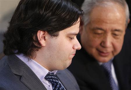 Mark Karpeles (L), chief executive of Mt. Gox, attends a news conference at the Tokyo District Court in Tokyo February 28, 2014. Mt. Gox, once the world's biggest bitcoin exchange, filed for bankruptcy protection on Friday, saying it may have lost all of its investors' virtual coins due to hacking into its faulty computer system. Karpeles, bowing in contrition and wearing a suit instead of his customary T-shirt, apologised in Japanese at a news conference for the company's collapse, blaming "a weakness in our system." REUTERS/Yuya Shino