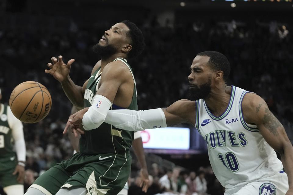 Minnesota Timberwolves' Mike Conley fouls Milwaukee Bucks' Malik Beasley during the first half of an NBA basketball game Thursday, Feb. 8, 2024, in Milwaukee. (AP Photo/Morry Gash)