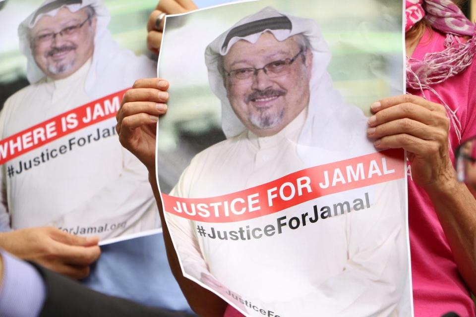 WASHINGTON, USA - OCTOBER 10: A member of the Organization 'Justice for Jamal Khashoggi' holds a picture of Khashoggi as she and other members hold news conference for disappearance of Saudi journalist in front of The Washington Post headquarters in Washington D.C. with the attendance of Congressman Gerry Connolly and figures from CAIR and Pen America spoke, in Washington D.C., United States on October 10, 2018. (Photo by Umar Farooq/Anadolu Agency/Getty Images)