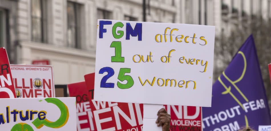 a protest sign opposing female genital mutilation