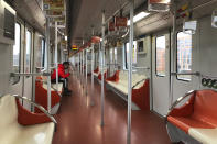 A man wears a face mask as he rides a nearly empty subway train near the Shanghai Disney Resort, which announced that it will be closed indefinitely from Saturday, in Shanghai, Saturday, Jan. 25, 2020. China's most festive holiday began in the shadow of a worrying new virus Saturday as the death toll surpassed 40, an unprecedented lockdown that kept people from traveling was expanded to more than 50 million residents and authorities canceled a host of Lunar New Year events. (AP Photo/Fu Ting)