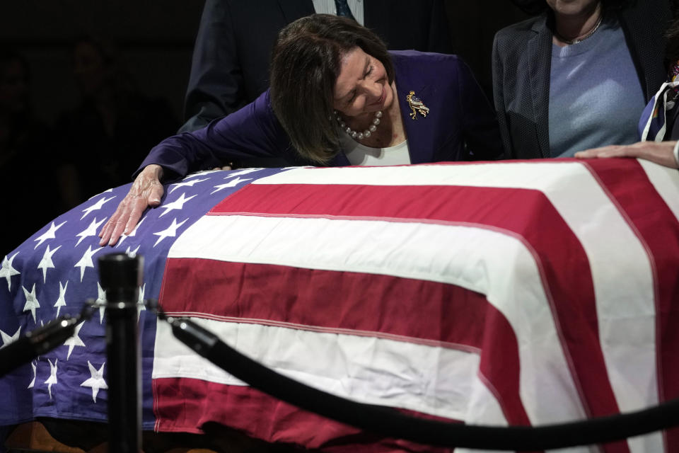 Rep. Nancy Pelosi, D-Calif., puts her arm around the casket of Sen. Dianne Feinstein at City Hall on Wednesday, Oct. 4, 2023, in San Francisco, where Feinstein's casket was displayed. Feinstein, who died Sept. 29, served as San Francisco mayor. (AP Photo/Godofredo A. Vásquez)