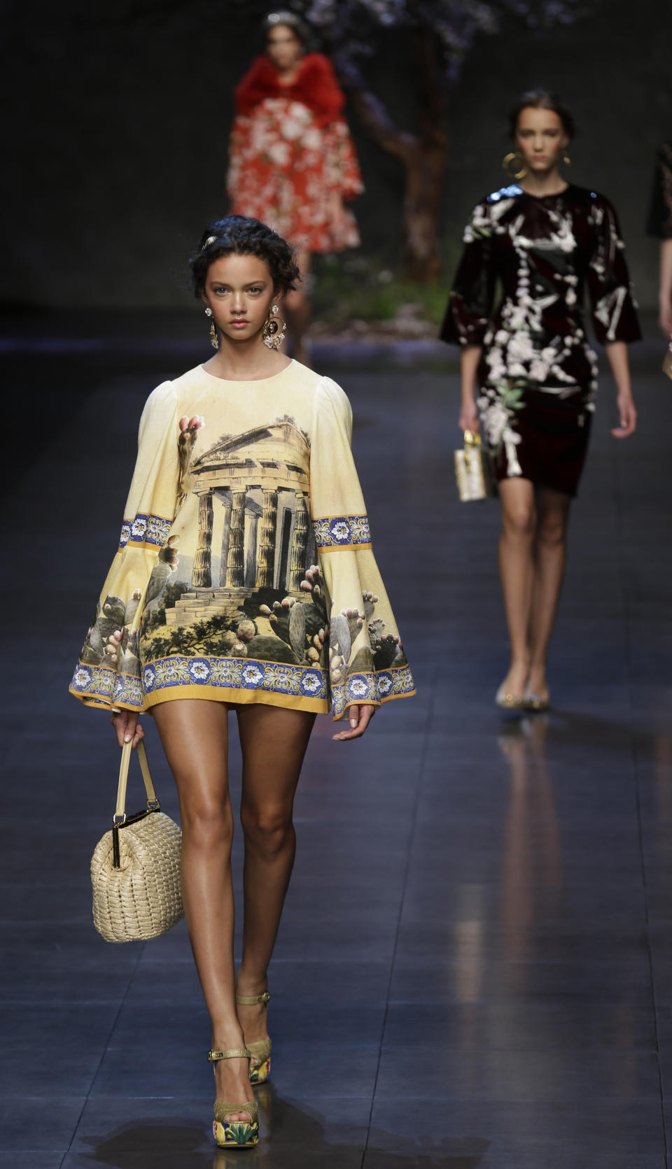 Models wear creations for Dolce & Gabbana women's Spring-Summer 2014 collection, part of the Milan Fashion Week, unveiled in Milan, Italy, Sunday, Sept. 22, 2013. (AP Photo/Luca Bruno)