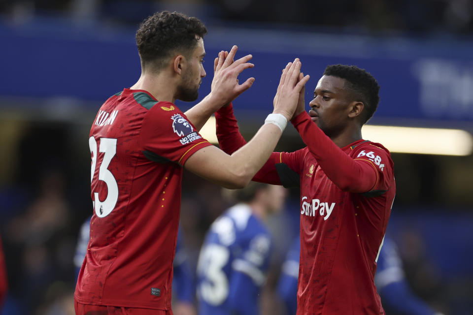 Wolverhampton Wanderers' Max Kilman, left and teammate Wolverhampton Wanderers' Nelson Semedo celebrate after the end of the English Premier League soccer match between Chelsea and Wolverhampton Wanderers at Stamford Bridge stadium in London, Sunday, Feb. 4, 2024. Wolves won the game 4-2. (AP Photo/Ian Walton)