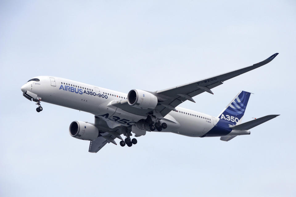 An Airbus A350-900 flies during an aerial display for a media preview ahead of the upcoming Singapore Air Show on Sunday, Feb. 9, 2014. (AP Photo/Joseph Nair)