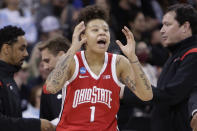 Ohio State guard Rikki Harris (1) reacts near the bench during the second half of a college basketball game against Texas in the Sweet 16 round of the NCAA tournament, Friday, March 25, 2022, in Spokane, Wash. Texas won 66-63. (AP Photo/Young Kwak)