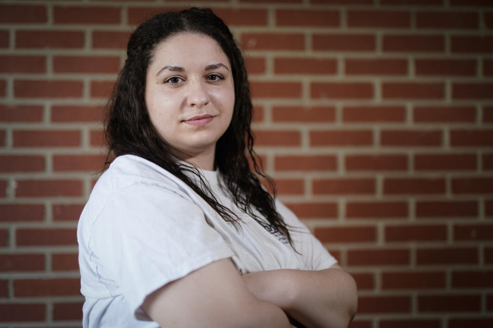 Laura Comino, a senior at the University of North Carolina at Greensboro poses for a picture on Tuesday, July 14, 2020, in Charlotte, N.C. College students are getting ready to return to school in August as the country deals with the coronavirus pandemic. More and more campuses are sparking frustration by releasing plans to keep students' housing payments, even if the campuses shut down again and go entirely online in the fall. (AP Photo/Chris Carlson)