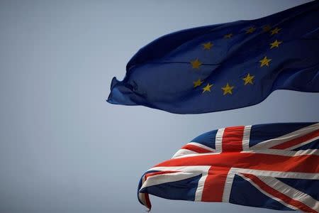 The Union Jack (bottom) and the European Union flag are seen flying, at the border of Gibraltar with Spain, in the British overseas territory of Gibraltar, historically claimed by Spain, June 27, 2016. REUTERS/Jon Nazca/Files