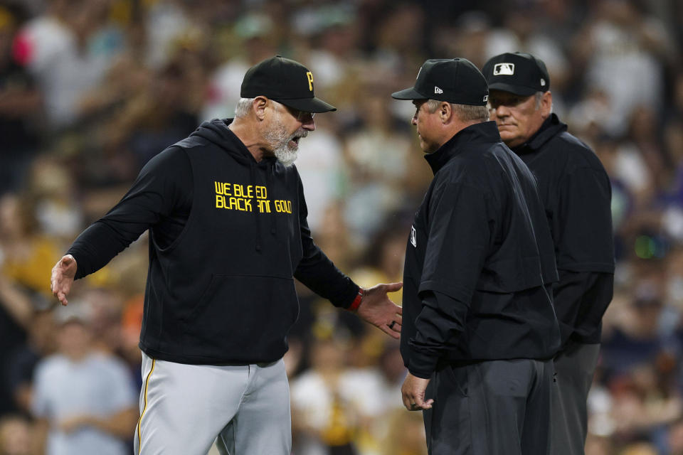 Pittsburgh Pirates manager Derek Shelton, left, argues with umpire Hunter Wendelstedt, center, as Marvin Hudson listens after Angel Perdomo was ejected for hitting San Diego Padres' Manny Machado with a pitch during the seventh inning of a baseball game Tuesday, July 25, 2023, in San Diego. (AP Photo/Derrick Tuskan)
