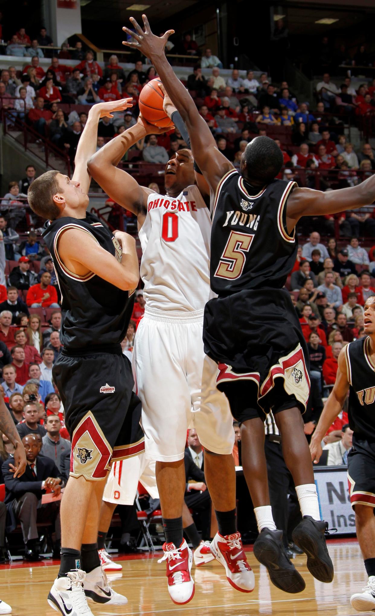 Ohio State Buckeyes forward Jared Sullinger (0) goes up against IUPUI Jaguars guard John Ashworth (42) and teammate Alex Young (5) in the second half of their NCAA men's basketball game at the Value City Arena, December 9, 2010. (Dispatch photo by Neal C. Lauron)