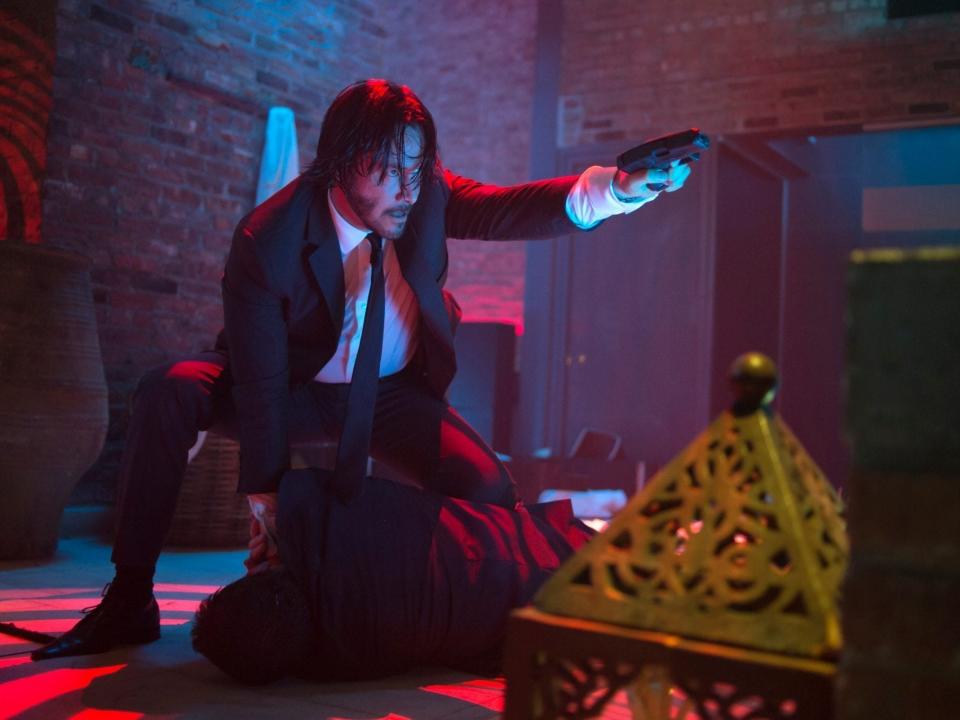 Keanu Reeves as John Wick in the Red Circle bathhouse and nightclub.