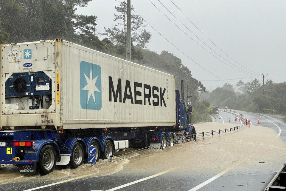 A truck is stopped by flood water near Auckland, New Zealand, Friday, Jan. 27, 2023. Torrential rain and wild weather in Auckland causes disruptions throughout the city and an Elton John concert to be canceled just before it was due to start. (Jed Bradley/New Zealand Herald via AP)