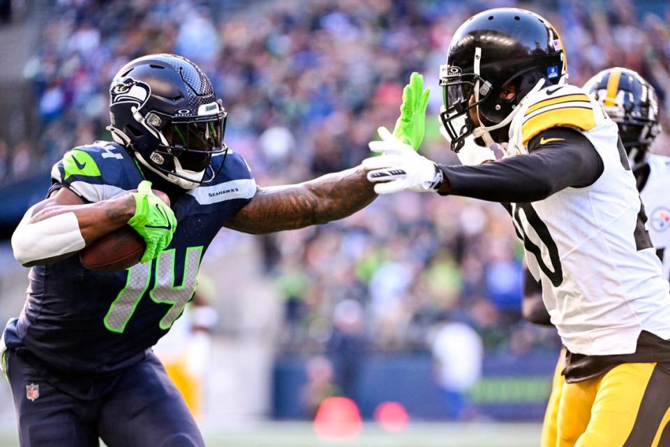 Seattle Seahawks wide receiver DK Metcalf (14) stiff arms Pittsburgh Steelers cornerback Patrick Peterson (20) after a 21-yard catch during the second quarter of the game at Lumen Field, on Sunday, Dec. 31, 2023, in Seattle, Wash.