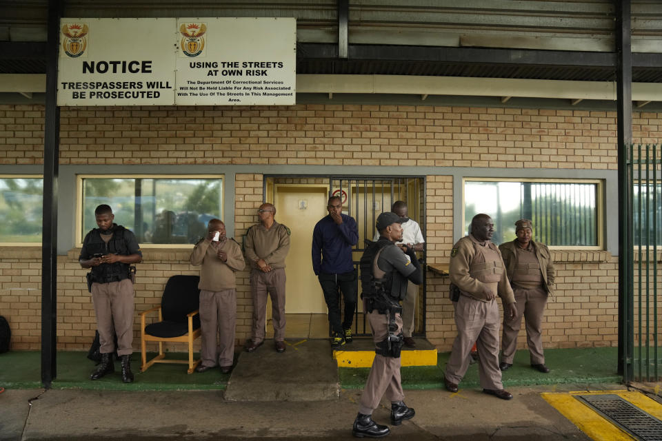 Prison staff at the entrance to the Atteridgeville Prison where Oscar Pistorius is being held, ahead of a parole hearing, in Pretoria, South Africa, Friday, March 31, 2023. The parents of Reeva Steenkamp, the woman Oscar Pistorius shot dead 10 years ago, will oppose the former Olympic runner's application for parole, their lawyer said Friday. (AP Photo/Themba Hadebe)