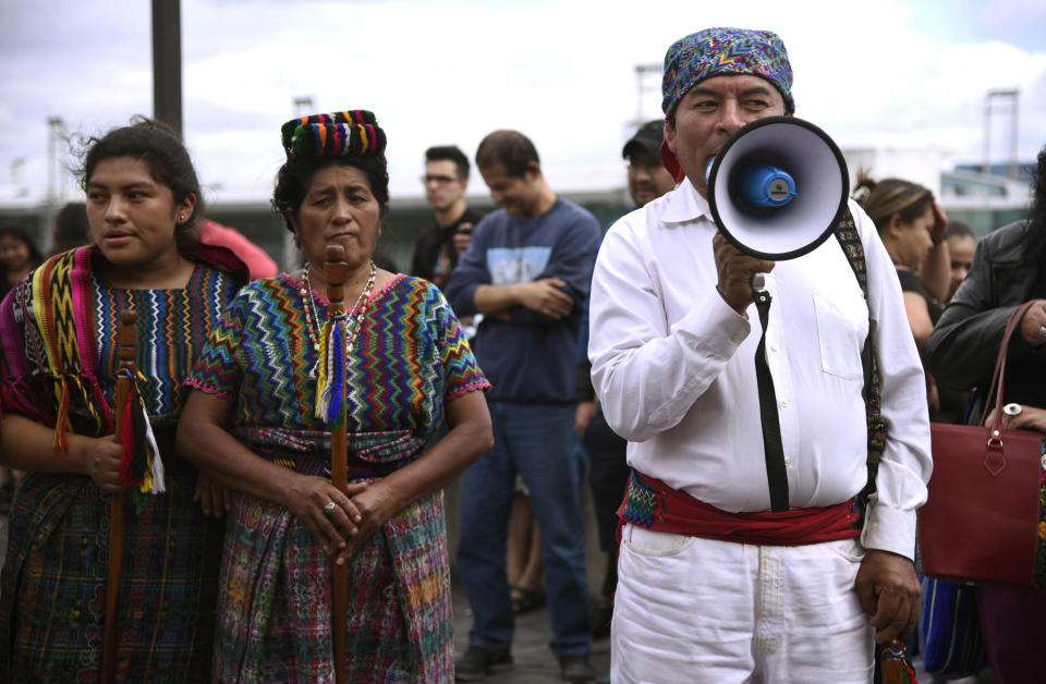 People rally to show support for the International Commission Against Impunity in Guatemala (CICIG) outside La Aurora International Airport in Guatemala City, Sunday, Jan. 6, 2019. Authorities are holding Colombian Yilen Osorio, a member of CICIG in the capital's airport, refusing him entry to the country in an escalation of tensions between the government and the commission. (AP Photo/Santiago Billy)