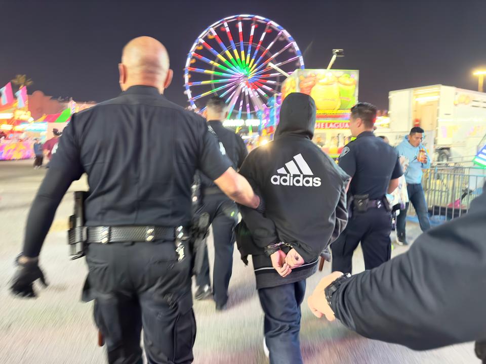 Ventura Police Department officers detain a person after a fight broke out at the Ventura County Fair on Friday.