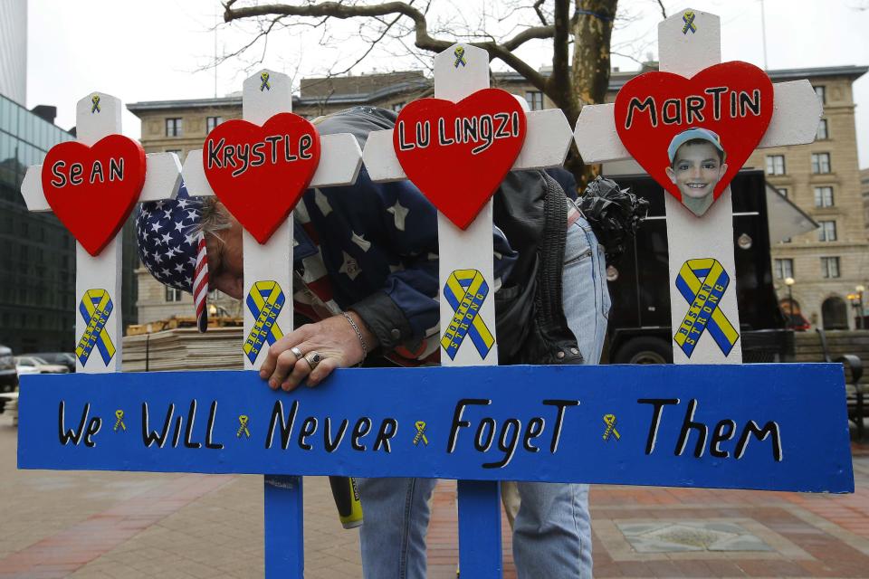 Kevin Brown puts up a hand made memorial for victims of the 2013 Boston Marathon bombings near the race's finish line in Boston, Massachusetts April 15, 2014, on the one year anniversary of the bombings. (REUTERS/Brian Snyder)