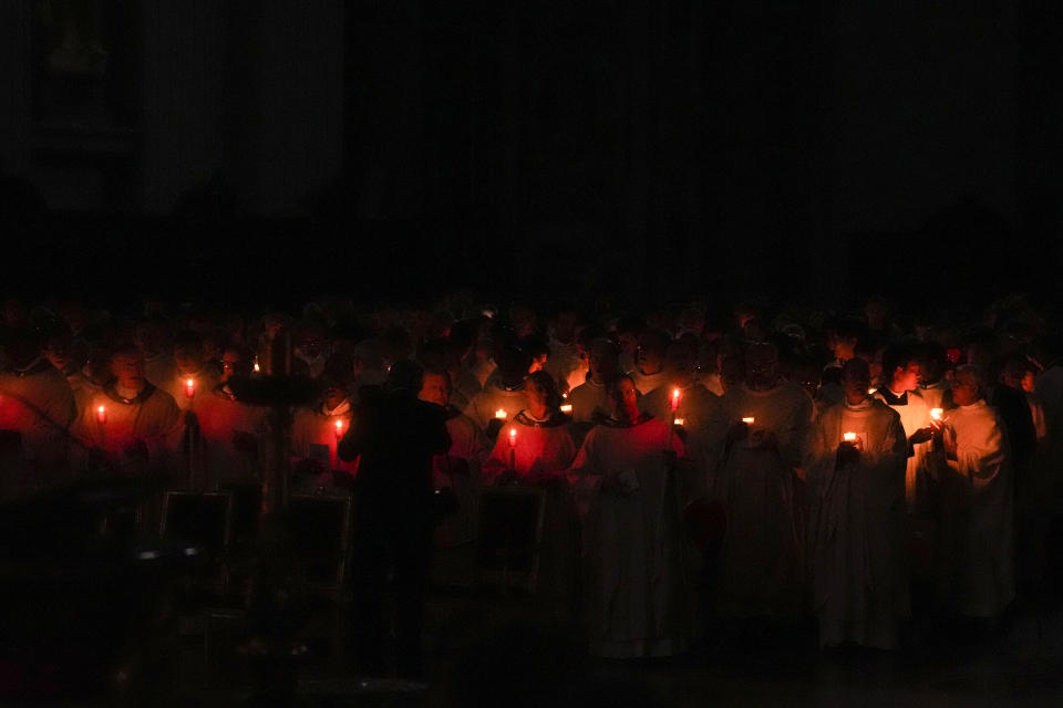 Cardinals hold candles as Pope Francis presides over an Easter vigil ceremony in St. Peter's Basilica at the Vatican, Saturday, April 8, 2023. (AP Photo/Gregorio Borgia)