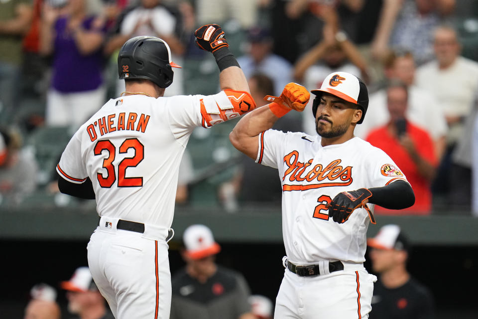 Baltimore Orioles' Ryan O'Hearn, left, is greeted near home plate by Anthony Santander after O'Hearn scored both of them on a two-run home run off Toronto Blue Jays starting pitcher Chris Bassitt during the third inning of a baseball game, Tuesday, June 13, 2023, in Baltimore. (AP Photo/Julio Cortez)