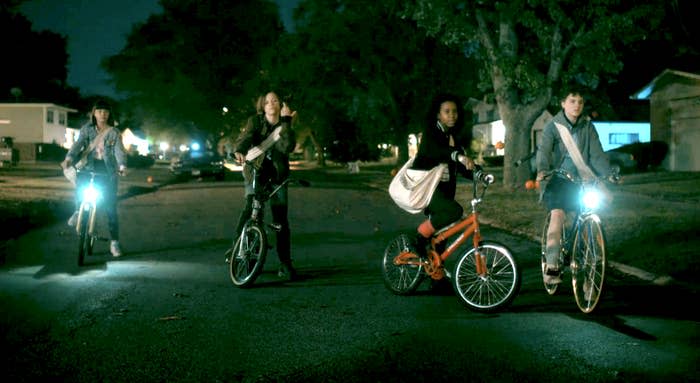 four characters riding bikes at night