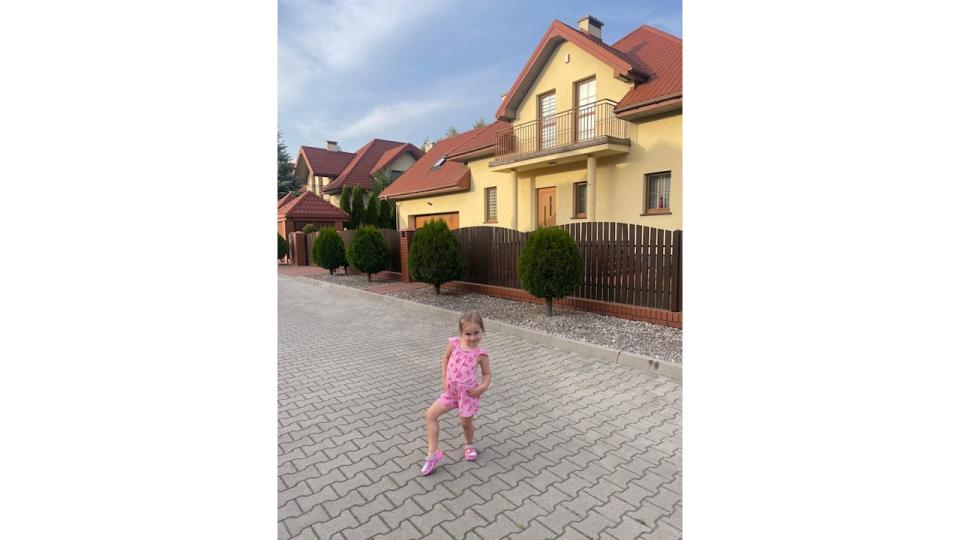 Ella Jordan poses in front of family home in Poland