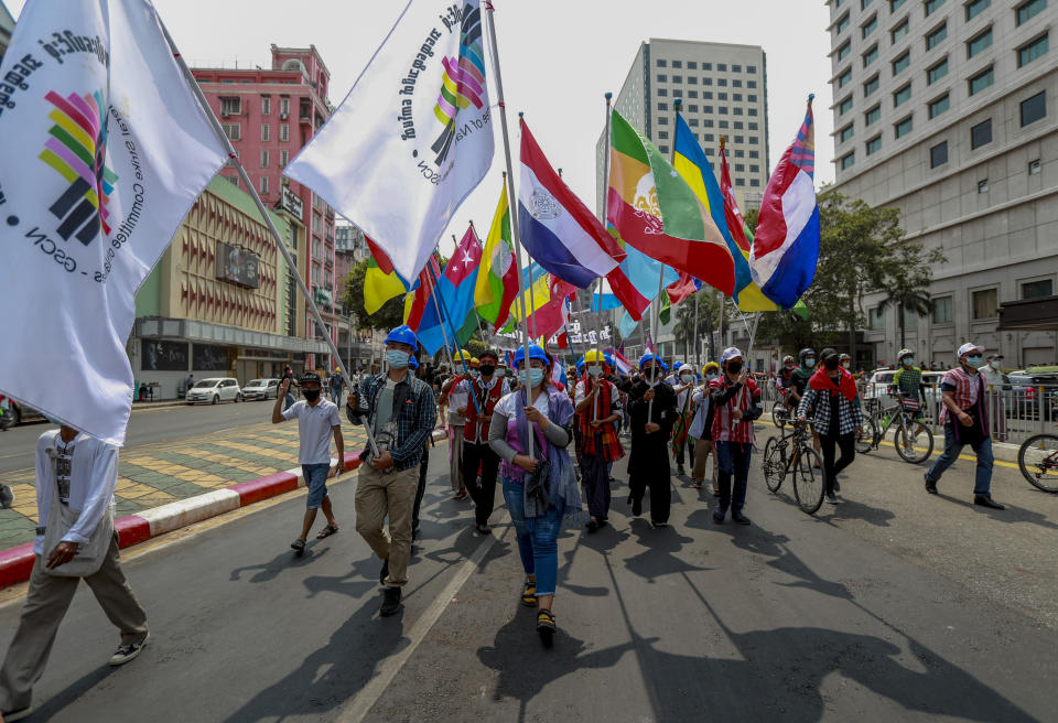 Demonstrators wave flags of different ethnic groups during a protest against the military coup in Yangon, Myanmar Thursday, Feb. 18, 2021. Demonstrators against Myanmar’s military takeover returned to the streets Thursday after a night of armed intimidation by security forces in the country’s second biggest city. (AP Photo)