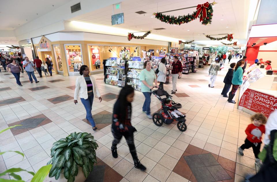 Shoppers walk around University Mall Wednesday, Dec. 23, 2015.  [Staff file photo]