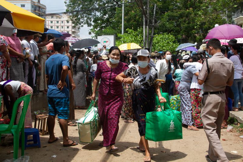 Relatives and friends wait outside the Insein Prison in Yangon