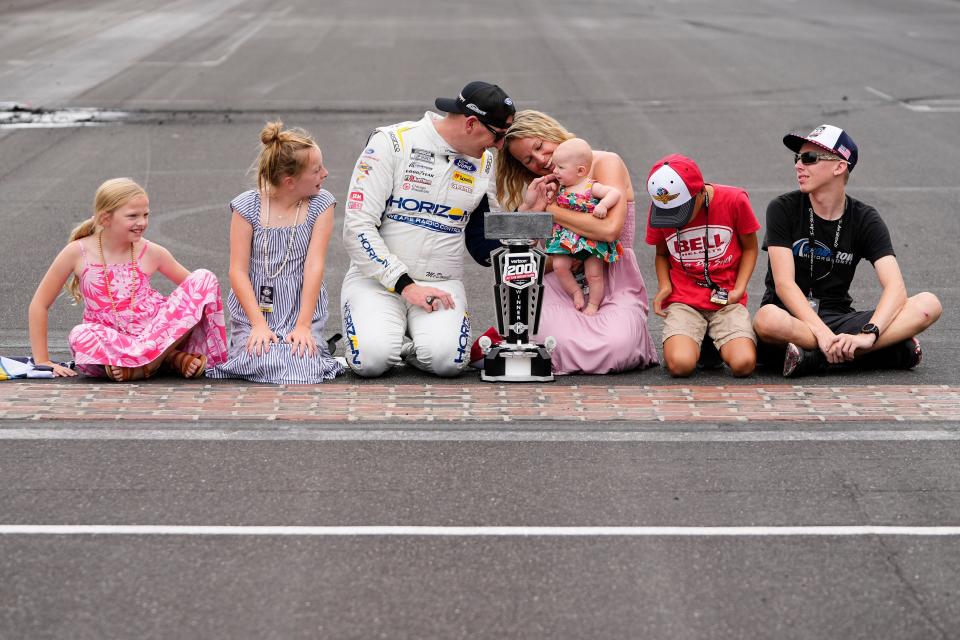 Michael McDowell (34) celebrates with his wife, Jami, and five children, Trace, Emma, Rylie, Lucas and Isabella following his win on Sunday at Indianapolis Motor Speedway.