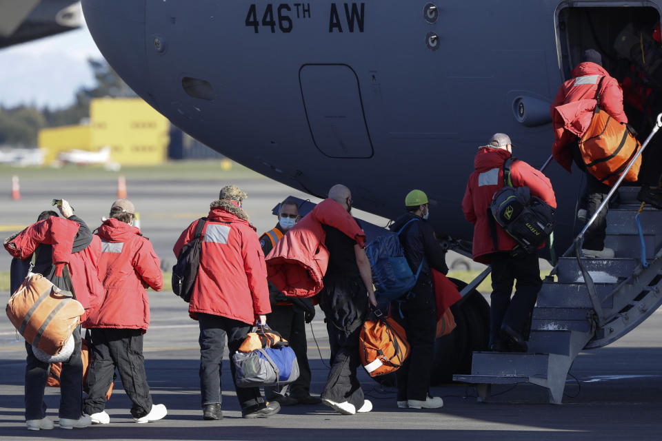 Staff board a U.S. Air Force C-17 as they prepare to take the season's first flight to McMurdo Station in Antarctica from Christchurch Airport, New Zealand, Monday, Sept. 14, 2020. The first U.S. flight into Antarctica following months of winter darkness left from New Zealand Monday with crews extra vigilant about keeping out the coronavirus. (AP Photo/Mark Baker)