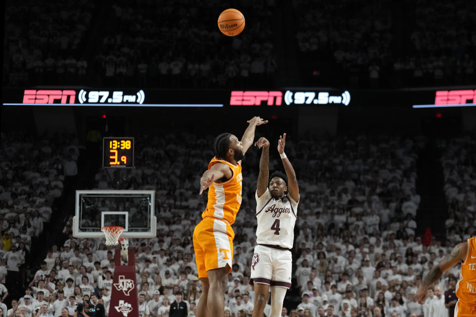Texas A&M guard Wade Taylor IV (4) makes a 3-point basket over Tennessee guard Josiah-Jordan James (30) during the first half of an NCAA college basketball game, Saturday, Feb. 10, 2024, in College Station, Texas. (AP Photo/Sam Craft)