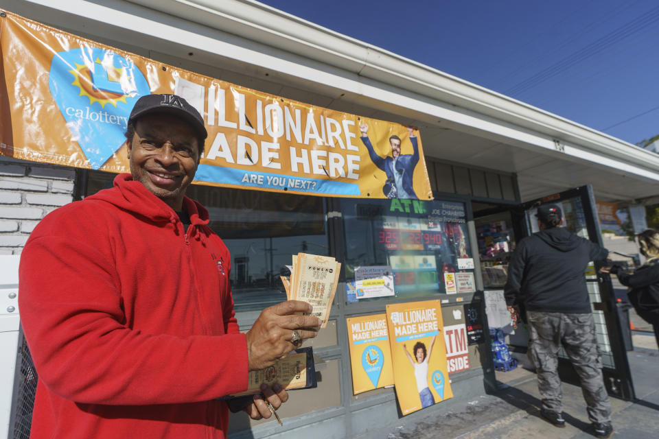 Community Leader and former Pasadena city commissioner Allen Shay buys California Lottery tickets to support his community at the gas station that sold the previous $2.04 billion-winning Powerball ticket award at Joe's Service Center, a Mobil gas station at Woodbury Road and Fair Oaks Avenue in Altadena, Calif., Friday, Jan. 6, 2023. Lottery players whose numbers didn't hit or who forgot to even buy a ticket will have another shot at a nearly $1 billion Mega Millions prize. The estimated $940 million jackpot up for grabs Friday night has been growing for more than two months and now ranks as the sixth-largest in U.S history. (AP Photo/Damian Dovarganes)