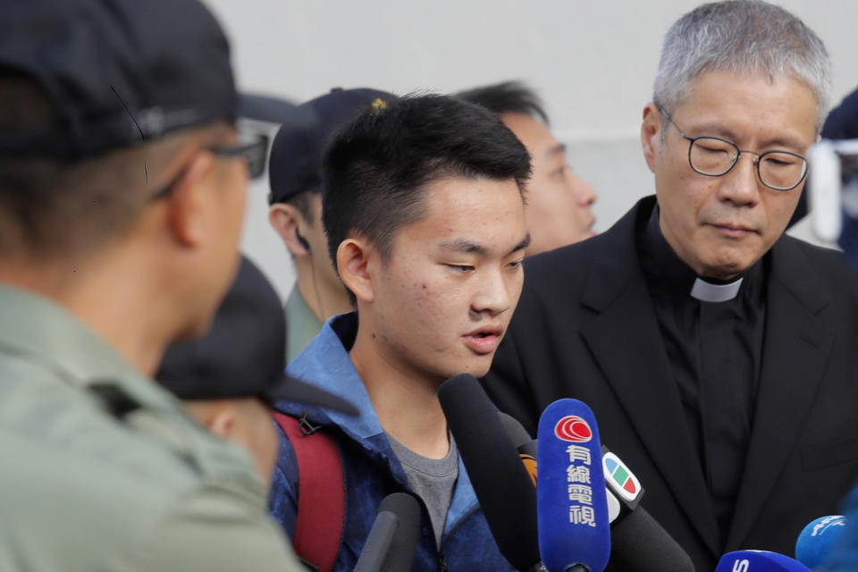 Chan Tong-kai, center, talks to the media as he is released from prison in Hong Kong Wednesday, Oct. 23, 2019. Chan, who's wanted for killing his girlfriend last year on the self-ruled island, had asked the Hong Kong government for help turning himself in to Taiwan after his sentence for money laundering offenses ends on Wednesday. (AP Photo/Kin Cheung)