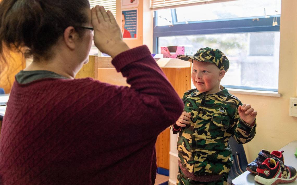 Crosby Orlando interacts with his special education teacher, Alexa Scarlett, at his school in Overland Park. Due to ongoing staff shortages, and a decade-long underfunding of special ed in Kansas, districts are strained as they work to provide needed services.