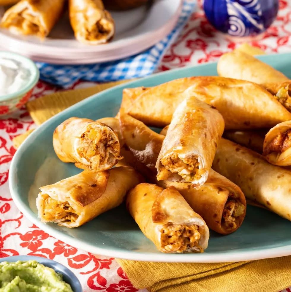 chicken taquitos on platter guacamole in corner