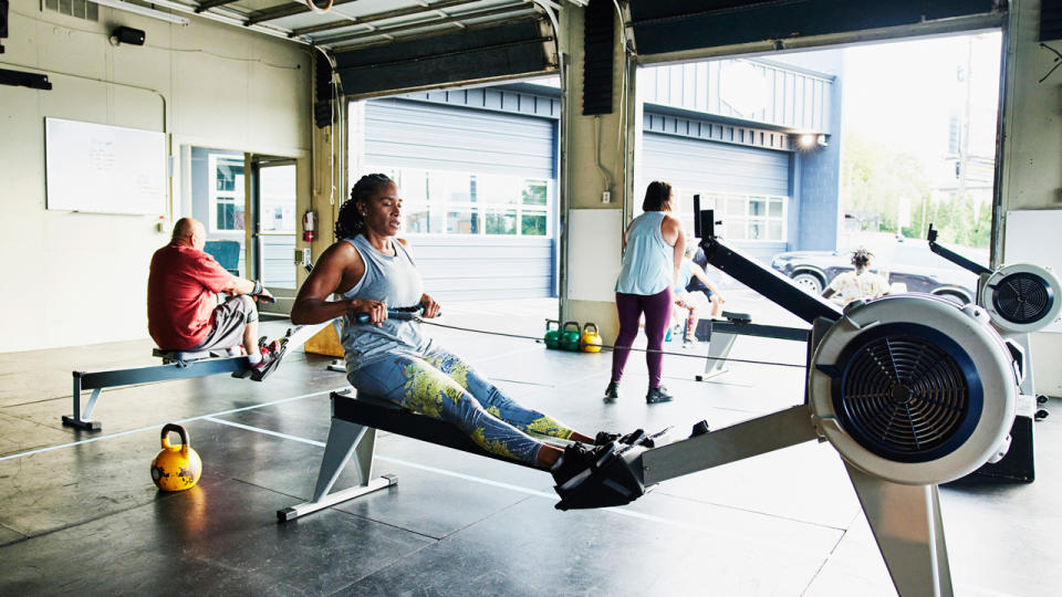 Woman using rowing machine in CrossFit gym
